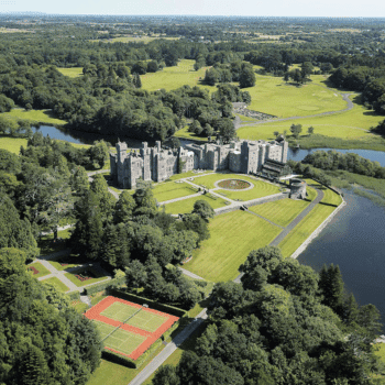 Aerial view of Ashford Castle and grounds beside the lake