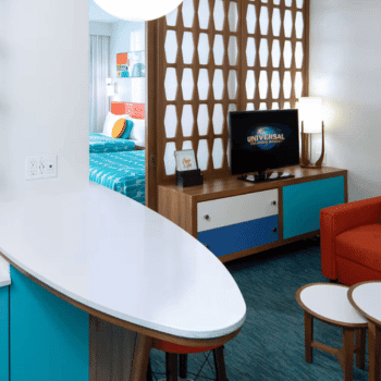 🏖️ Cabana Bay Beach Resort Review with Volcano Bay View – A Fantastic Family Hotel 14 Family suite interior with colourful furniture, TV, partition, and visible bedroom area