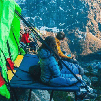 Guests camping on a suspended portaledge with dramatic cliff views