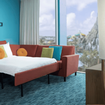 🏖️ Cabana Bay Beach Resort Review with Volcano Bay View – A Fantastic Family Hotel 16 Red sofa bed next to large window with view of Volcano Bay's iconic volcano
