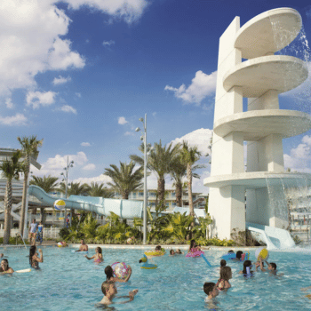🏖️ Cabana Bay Beach Resort Review with Volcano Bay View – A Fantastic Family Hotel 18 amilies and kids swimming at Cabana Bay’s main pool with retro-styled waterslide tower and splash fountain