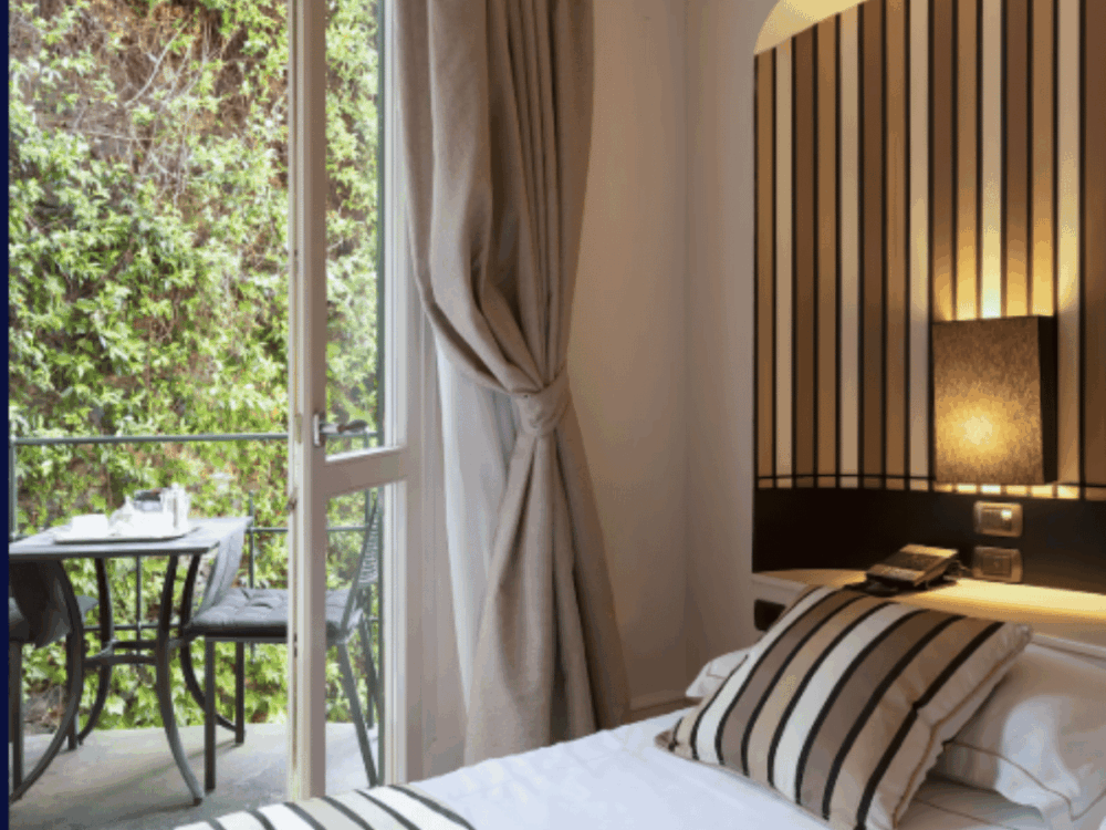 Bedroom with balcony overlooking gardens at Eight Hotel Portofino