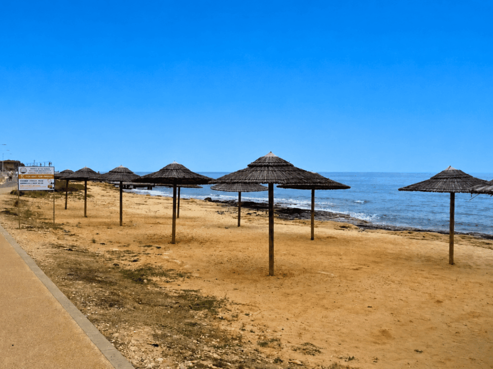 Coastal promenade with beach umbrellas beside the sea in Ayia Napa