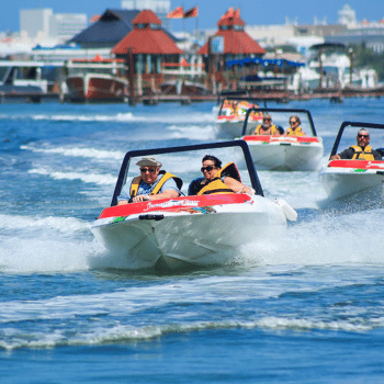 Twin-seat speedboat zipping through lush jungle waterways in Cancun under bright skies