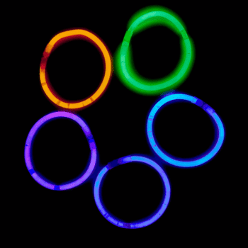 🎃 Spooky Season Travel Deals & Haunted Adventures ✈️👻 24 Six colourful glow stick bracelets in orange, green, blue, and purple glowing against a black background.