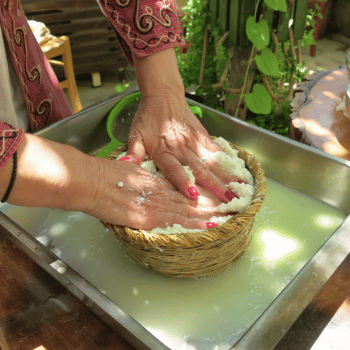Ayia Napa in May – A Mum & Daughter Escape 🌊☀️ 49 Hands pressing fresh cheese curds in a woven basket during a traditional cheesemaking process in Cyprus