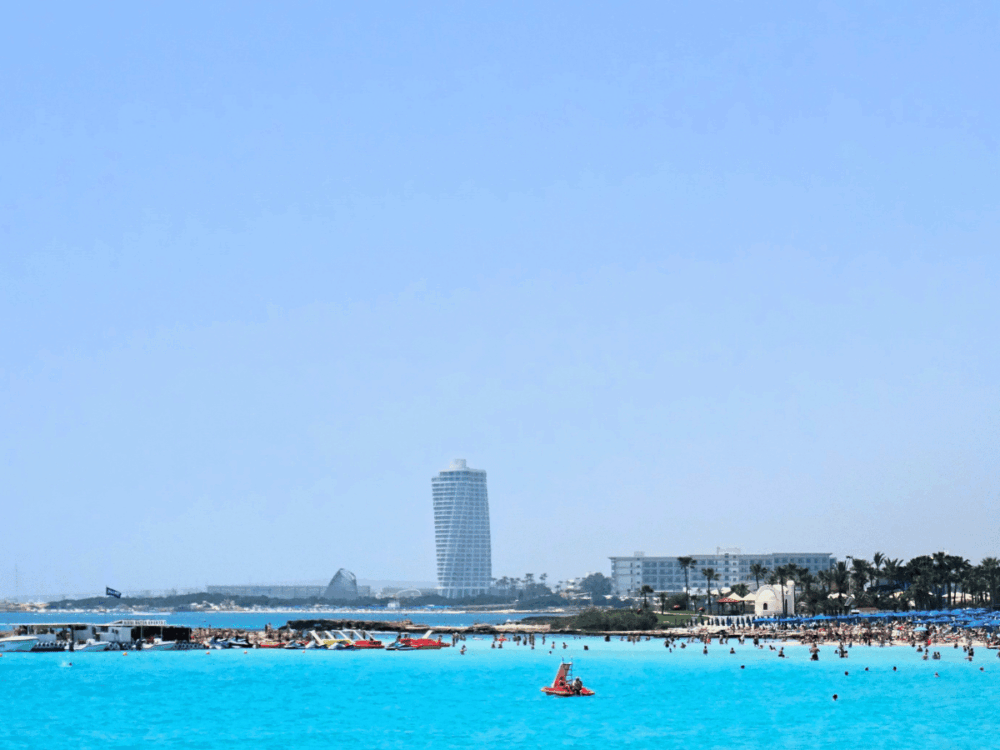View across Nissi Beach with turquoise water and hotels in the distance