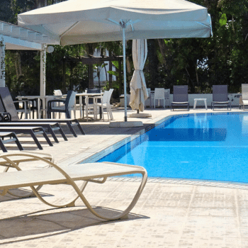 Ayia Napa in May – A Mum & Daughter Escape 🌊☀️ 4 Outdoor pool with shaded seating and dining area at La Casa Di Napa