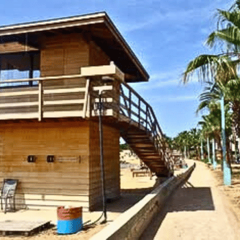 Ayia Napa in May – A Mum & Daughter Escape 🌊☀️ 19 Wooden lifeguard tower beside a palm-lined promenade on the beach