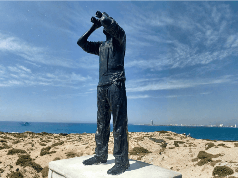Bronze fisherman statue overlooking the sea in Ayia Napa