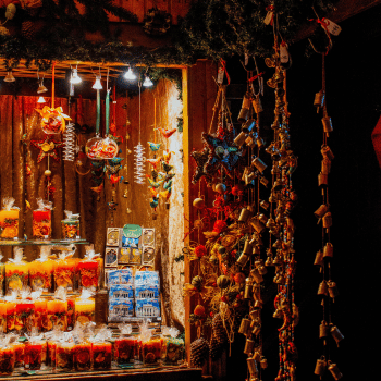 Compare Flights and Travel Essentials 16 Colourful handmade decorations and festive treats on display at a warmly lit Christmas market stall in Vienna