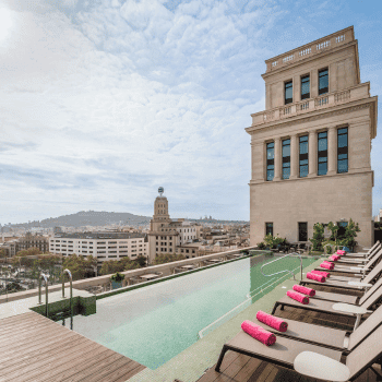 Rooftop swimming pool with loungers overlooking Barcelona skyline at 45 Times Barcelona