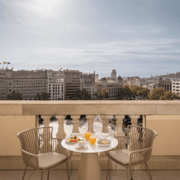 Table set for breakfast on balcony with Barcelona city views at 45 Times Barcelona