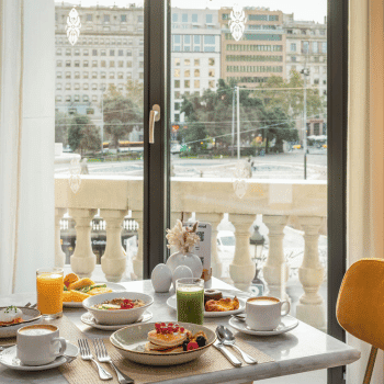 Breakfast table set with food and drinks overlooking Plaça de Catalunya from 45 Times Barcelona