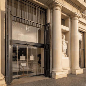 Grand entrance with columns and statues at 45 Times Barcelona hotel in Barcelona