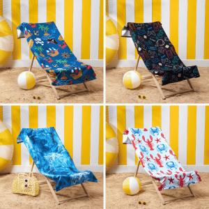 Compare Flights and Travel Essentials 56 Four OHS beach towels in bright designs displayed on deckchairs in a beach setup