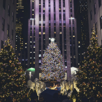 Compare Flights and Travel Essentials 43 Rockefeller Center Christmas Tree surrounded by lit-up evergreens and holiday angels in New York City