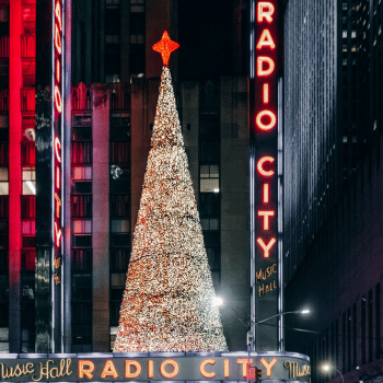 Compare Flights and Travel Essentials 46 Radio City Music Hall with illuminated Christmas tree in New York City at night