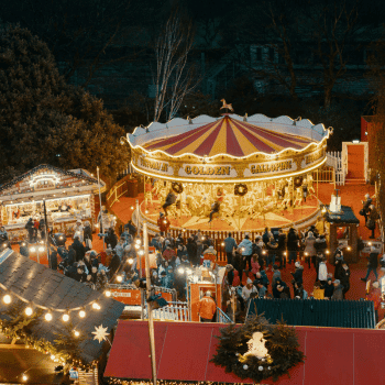 Compare Flights and Travel Essentials 47 Carousel and festive stalls at the Edinburgh Christmas Market in Princes Street Gardens at night