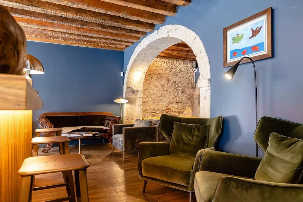Compare Flights and Travel Essentials 98 Stylish lounge area with exposed stone arches inside Dare Lisbon House