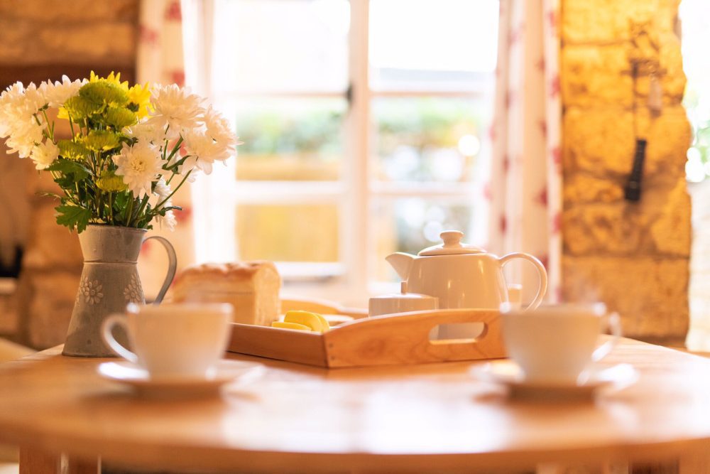 Compare Flights and Travel Essentials 77 Cosy cottage breakfast table with tea, flowers and soft morning light