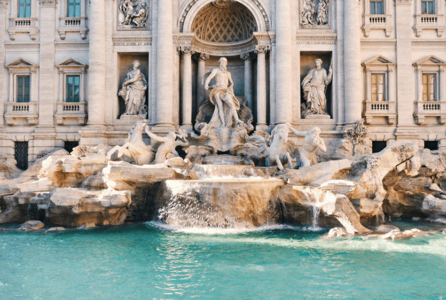 Compare Flights and Travel Essentials 30 Trevi Fountain in Rome with sculpted figures, flowing water and visitors gathered around the fountain