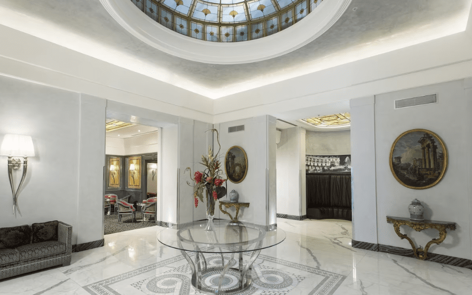 Compare Flights and Travel Essentials 34 Elegant hotel lobby interior at Hotel Artemide Rome with marble floors and classic décor