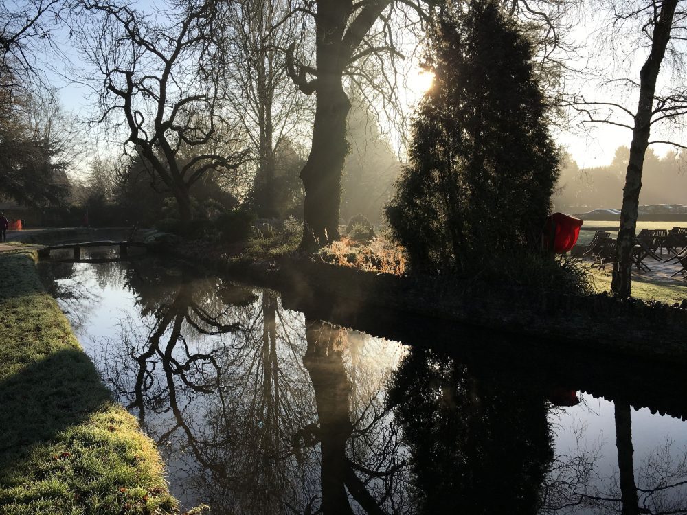 Compare Flights and Travel Essentials 76 Winter morning light reflecting on the river in Bourton-on-the-Water village