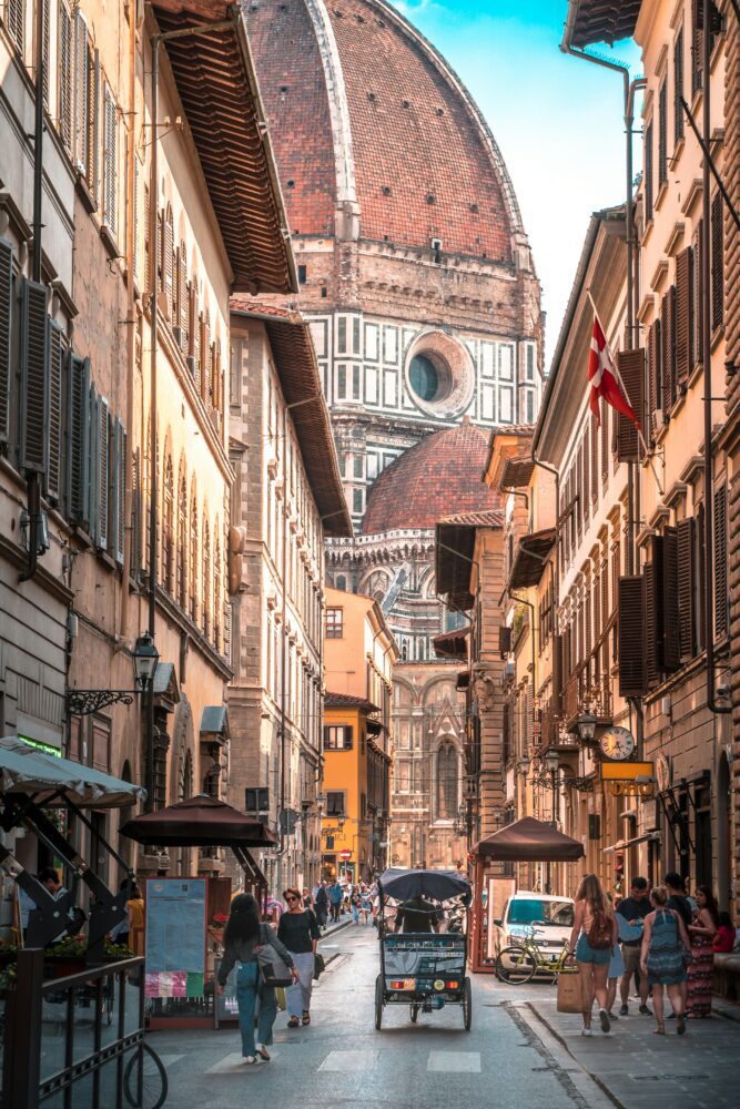 Compare Flights and Travel Essentials 94 Street view in Florence leading towards the Duomo dome
