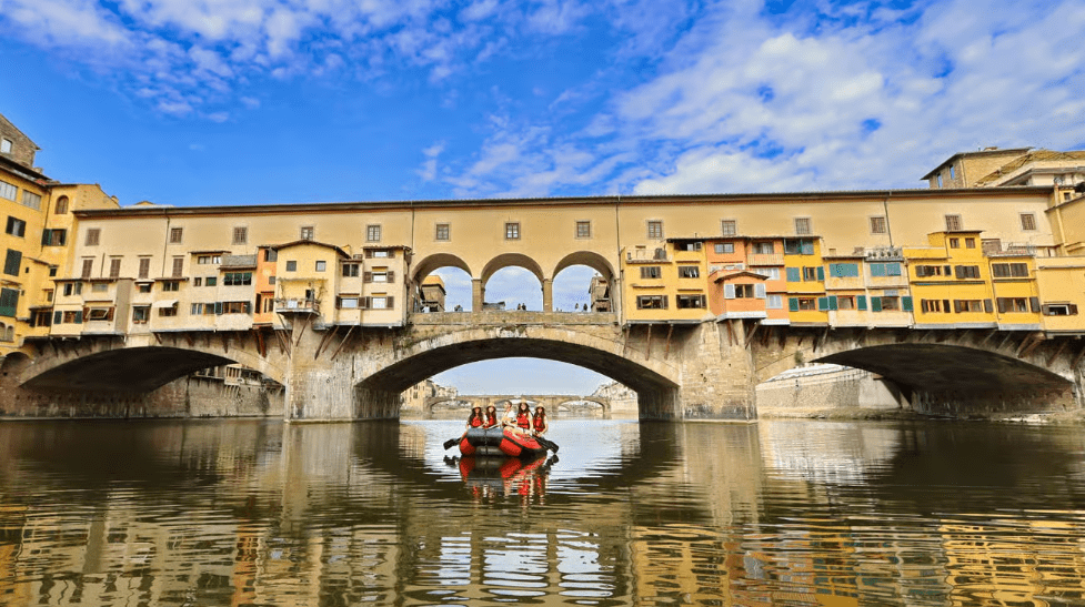 Compare Flights and Travel Essentials 91 Small boat passing under Ponte Vecchio on the River Arno in Florence