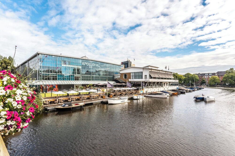 Compare Flights and Travel Essentials 102 Exterior view of Apollo Hotel Amsterdam beside the canal and marina