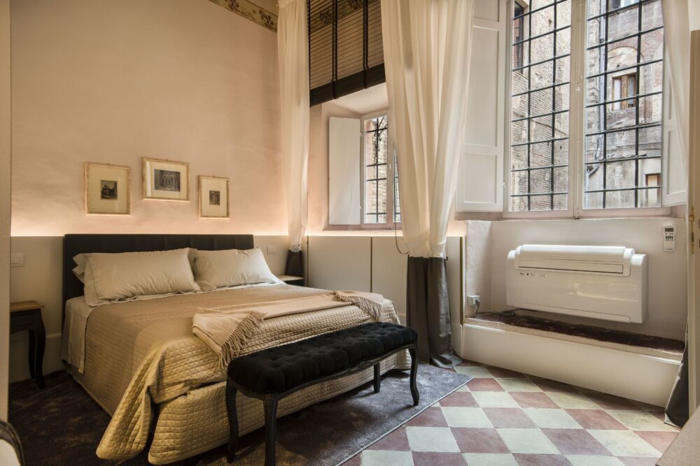 Compare Flights and Travel Essentials 27 Elegant hotel bedroom with tall shuttered windows and tiled floor
