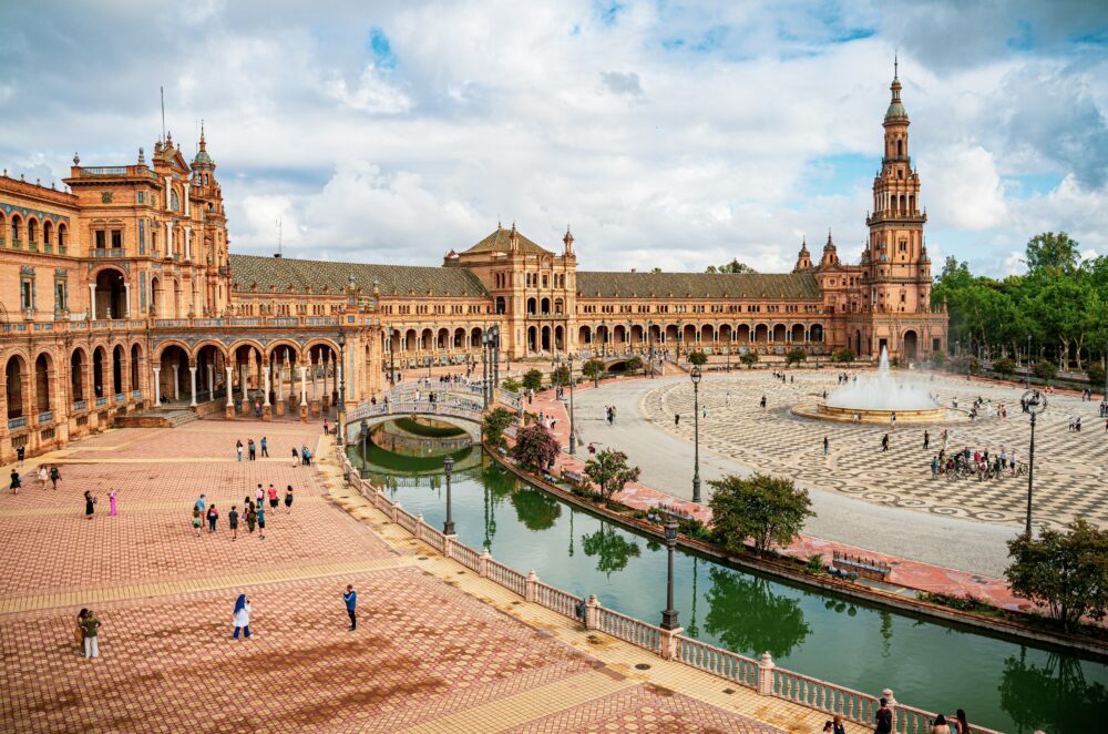 Compare Flights and Travel Essentials 25 Wide view of Plaza de España square with fountain and canal