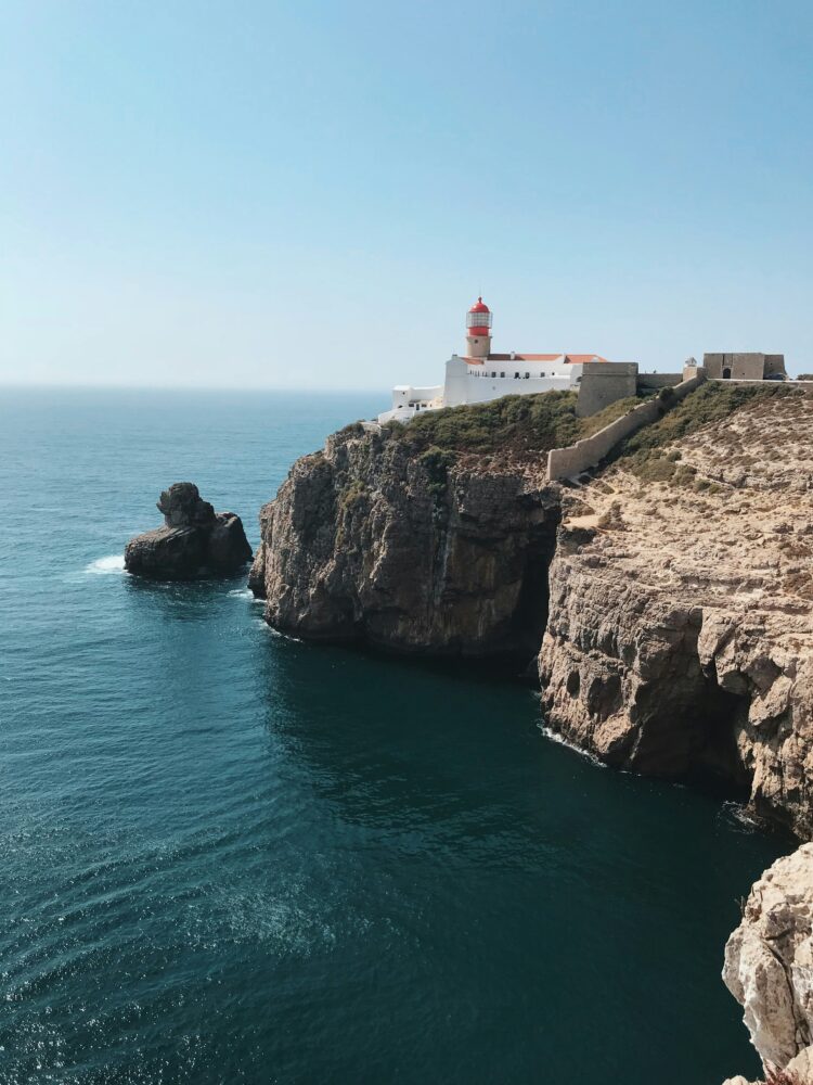 Compare Flights and Travel Essentials 46 Clifftop lighthouse overlooking the Atlantic Ocean in southern Portugal