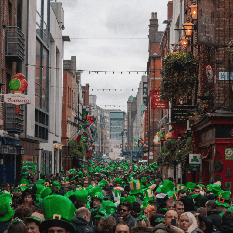 Crowds wearing green hats celebrating St Patrick’s Day in Temple Bar
