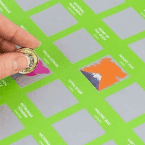 Close view of the 100 Places Bucket List Scratch Poster with several scratched destinations revealing colourful images of famous travel locations.