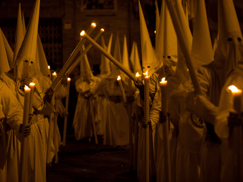 Semana Santa night procession with candlelight and hooded participants