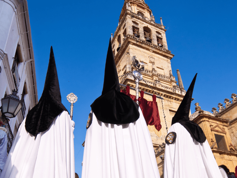 Semana Santa procession near Seville Cathedral with hooded participants
