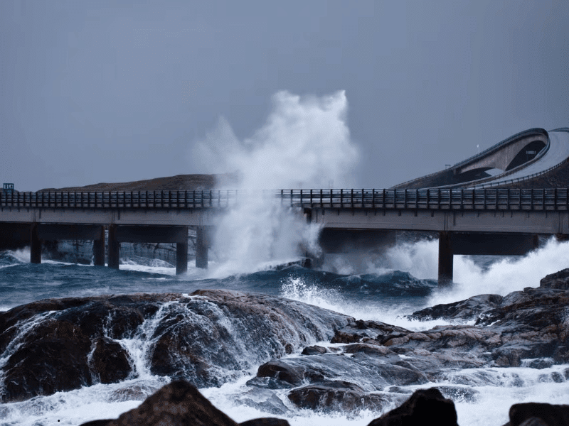 Waves crashing against bridge during storm