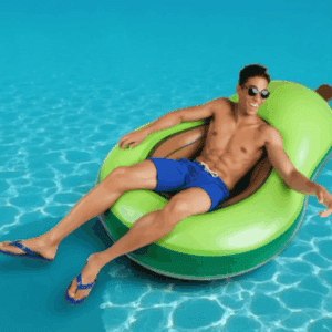 Person relaxing on avocado pool float in a swimming pool on holiday