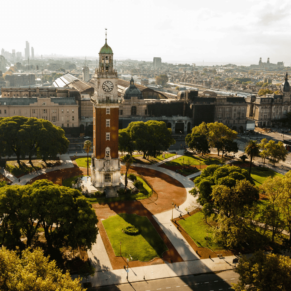 Historic clock tower surrounded by plaza and city buildings from above