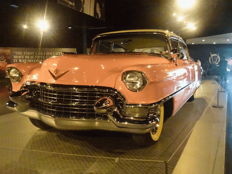Pink Cadillac car displayed in museum setting