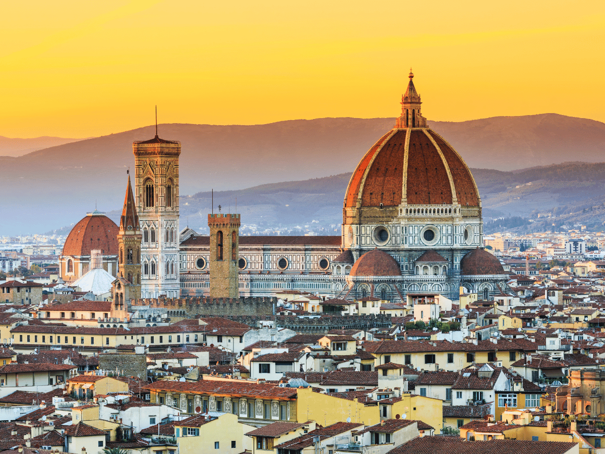 Florence Cathedral dome above the city skyline at sunset