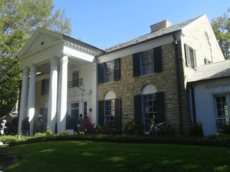 Exterior of Graceland mansion with columns and garden