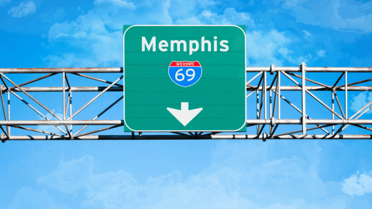Memphis Interstate 69 road sign on overhead highway gantry against a blue sky backdrop.