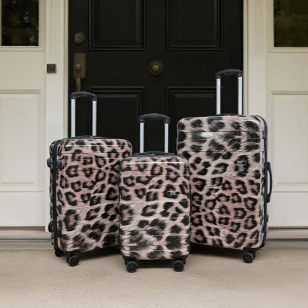 OHS 4 Wheel Hard Shell Suitcase 3 Leopard print hard shell suitcase set with four wheels placed outside ready for a trip