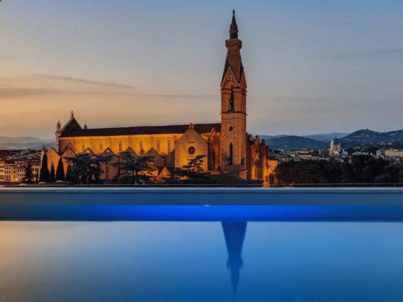 Rooftop pool overlooking Florence skyline and historic buildings