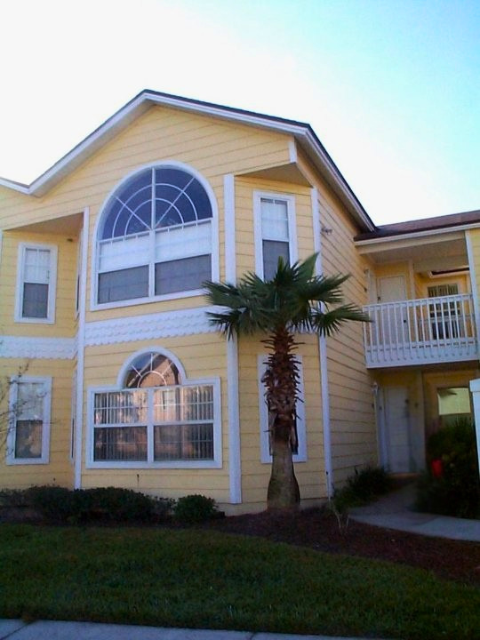 Summer Holidays 35 Resort holiday home exterior with palm tree and shared walkway