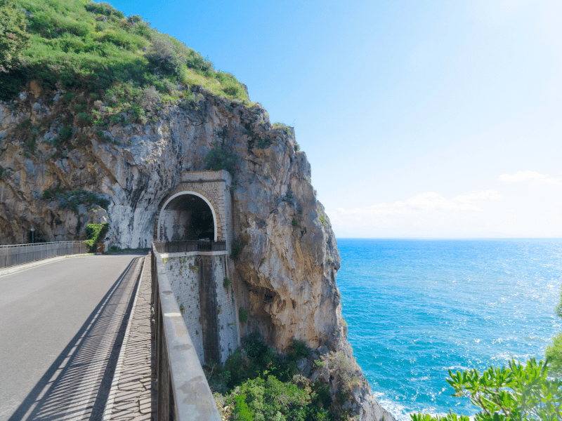 Car Hire 6 Coastal road passing through a tunnel on the Amalfi Coast, Italy.