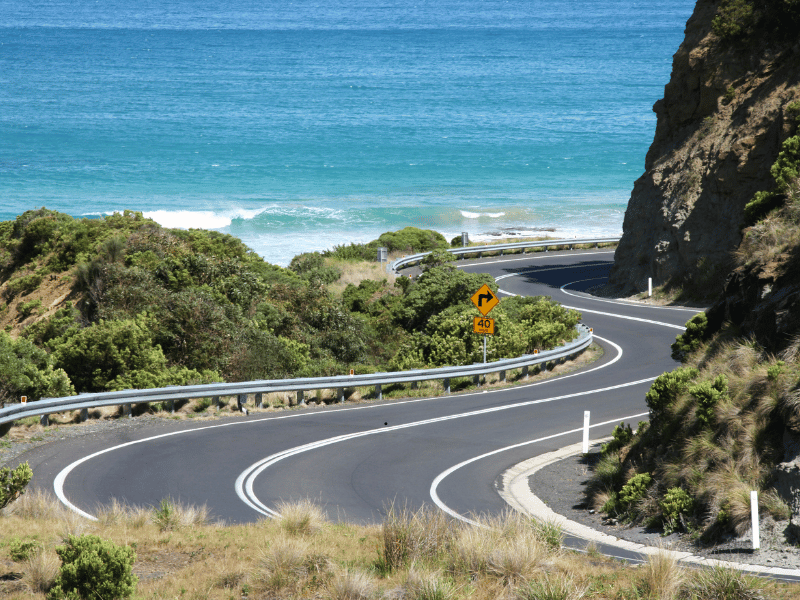 Car Hire 7 Winding coastal road beside the sea on the Great Ocean Road, Australia.